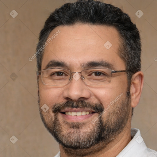 Joyful white adult male with short  black hair and brown eyes