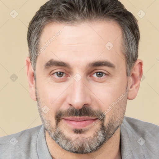 Joyful white adult male with short  brown hair and brown eyes