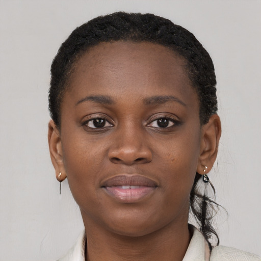 Joyful black young-adult female with short  brown hair and brown eyes