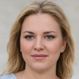 Joyful white young-adult female with medium  brown hair and blue eyes