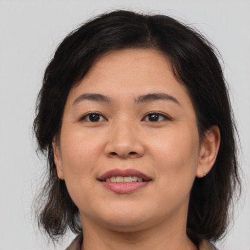 Joyful asian young-adult female with medium  brown hair and brown eyes