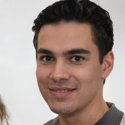 Joyful white young-adult male with short  black hair and brown eyes