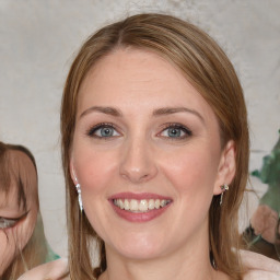 Joyful white young-adult female with medium  brown hair and blue eyes