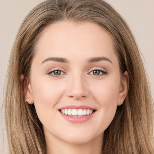 Joyful white young-adult female with long  brown hair and grey eyes