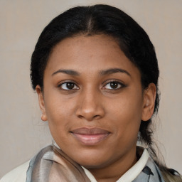 Joyful latino young-adult female with medium  brown hair and brown eyes