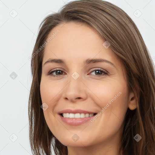 Joyful white young-adult female with long  brown hair and brown eyes