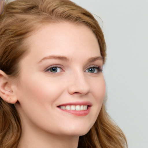 Joyful white young-adult female with long  brown hair and blue eyes