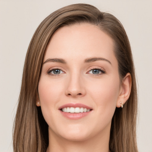 Joyful white young-adult female with long  brown hair and grey eyes