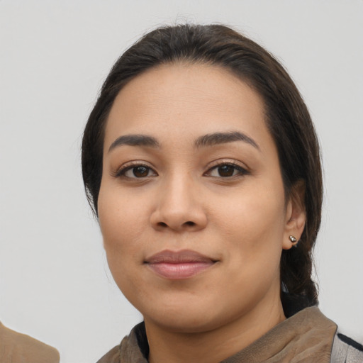 Joyful latino young-adult female with medium  black hair and brown eyes