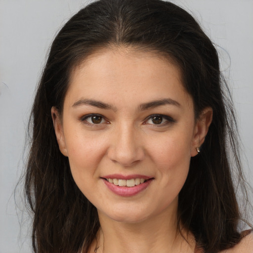 Joyful white young-adult female with long  brown hair and brown eyes