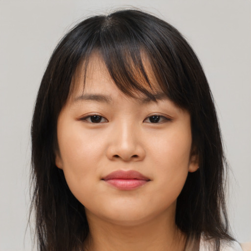 Joyful asian young-adult female with long  brown hair and brown eyes