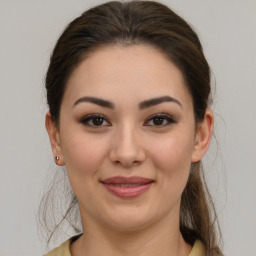 Joyful white young-adult female with medium  brown hair and brown eyes