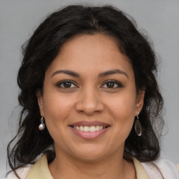 Joyful latino young-adult female with medium  brown hair and brown eyes