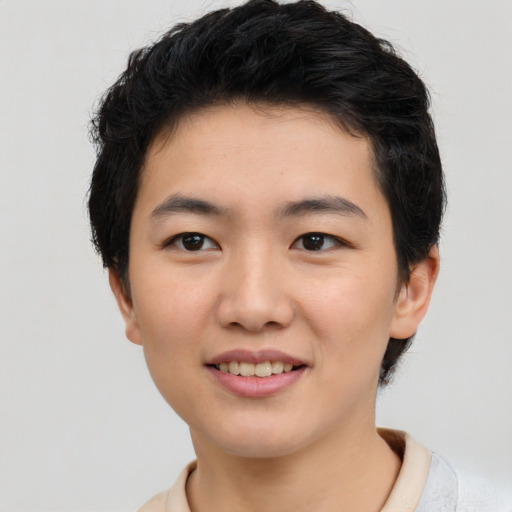 Joyful asian young-adult male with short  black hair and brown eyes