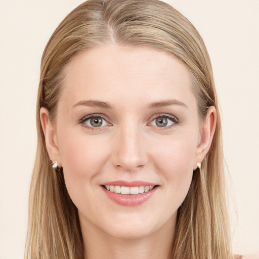 Joyful white young-adult female with long  brown hair and blue eyes