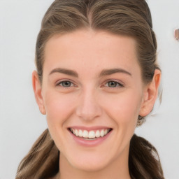 Joyful white young-adult female with long  brown hair and blue eyes