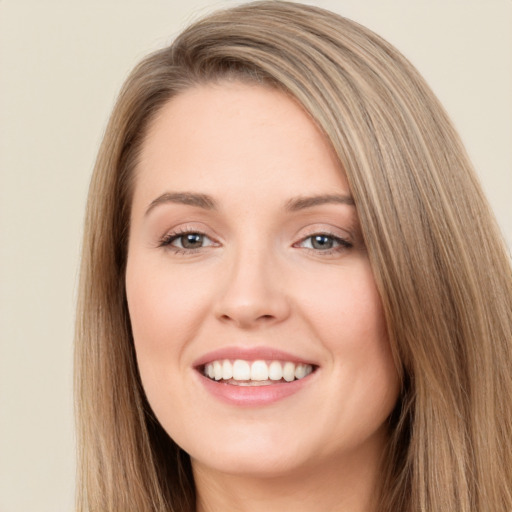 Joyful white young-adult female with long  brown hair and brown eyes