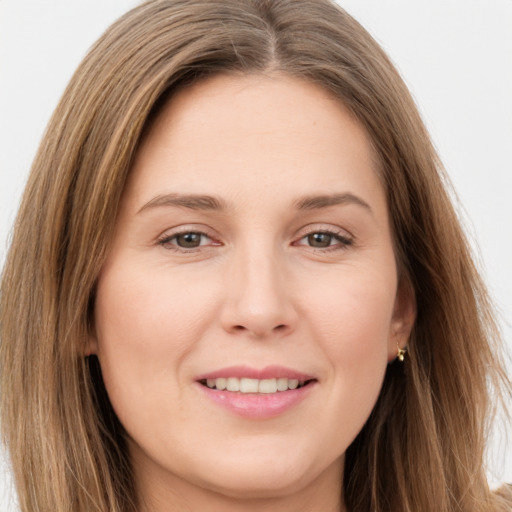 Joyful white young-adult female with long  brown hair and brown eyes