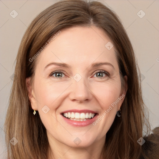 Joyful white adult female with long  brown hair and grey eyes