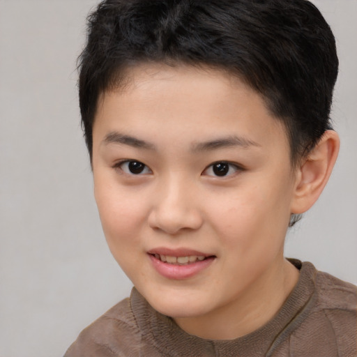 Joyful asian child female with short  brown hair and brown eyes