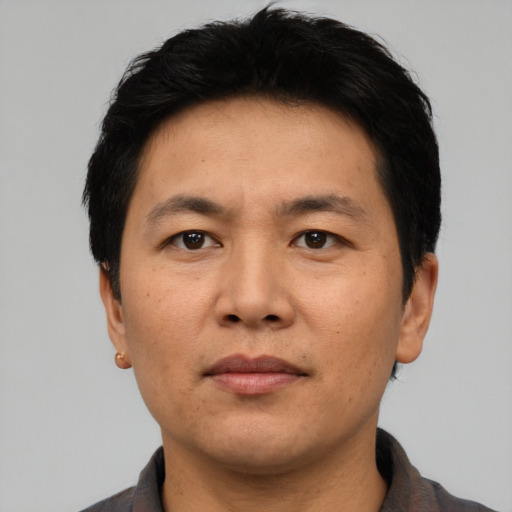 Neutral asian adult male with short  black hair and brown eyes