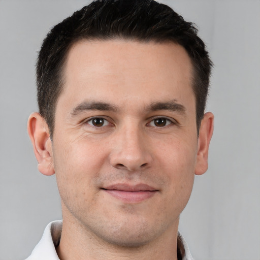 Joyful white young-adult male with short  brown hair and brown eyes