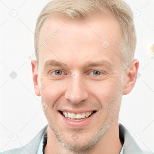 Joyful white adult male with short  brown hair and blue eyes