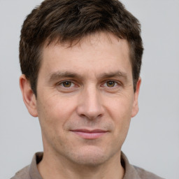 Joyful white adult male with short  brown hair and grey eyes