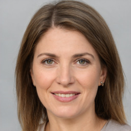 Joyful white adult female with medium  brown hair and grey eyes