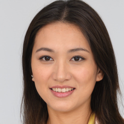 Joyful white young-adult female with long  brown hair and brown eyes