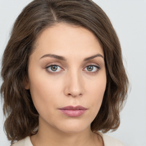 Neutral white young-adult female with medium  brown hair and green eyes