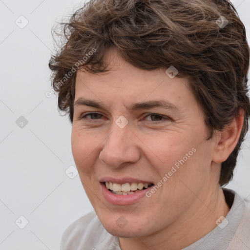 Joyful white adult female with short  brown hair and brown eyes