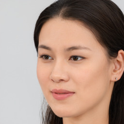 Joyful asian young-adult female with long  brown hair and brown eyes