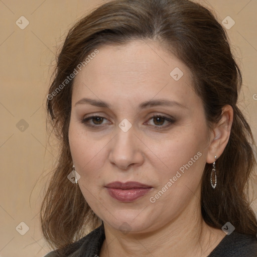 Joyful white adult female with long  brown hair and brown eyes