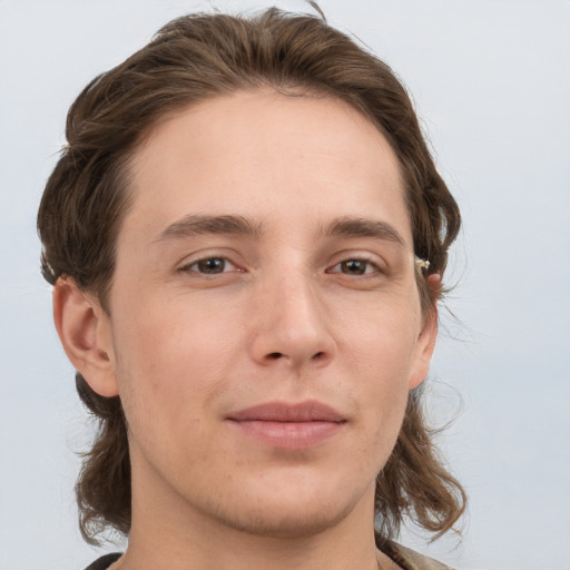 Joyful white young-adult male with medium  brown hair and grey eyes