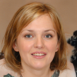 Joyful white young-adult female with medium  brown hair and blue eyes