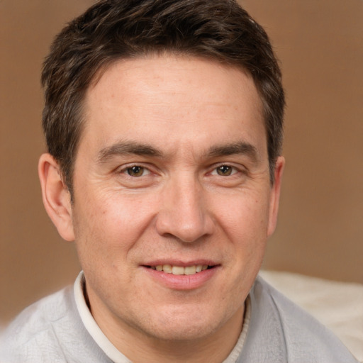 Joyful white adult male with short  brown hair and brown eyes