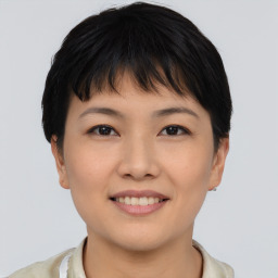 Joyful asian young-adult female with short  brown hair and brown eyes