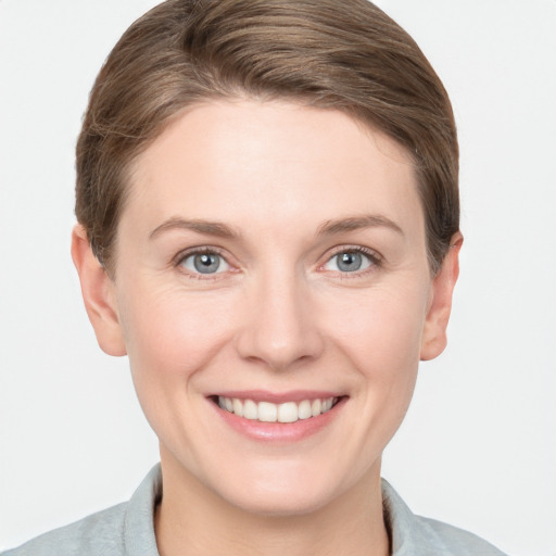 Joyful white young-adult female with short  brown hair and grey eyes