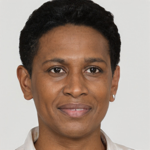 Joyful black adult male with short  black hair and brown eyes
