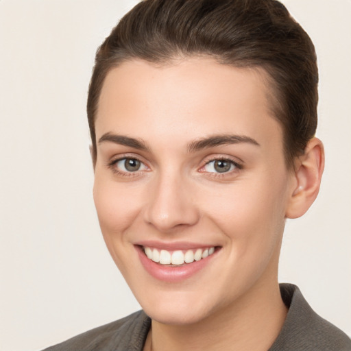 Joyful white young-adult female with short  brown hair and brown eyes