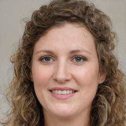 Joyful white young-adult female with medium  brown hair and green eyes