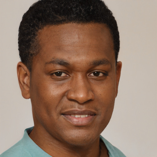 Joyful black young-adult male with short  brown hair and brown eyes