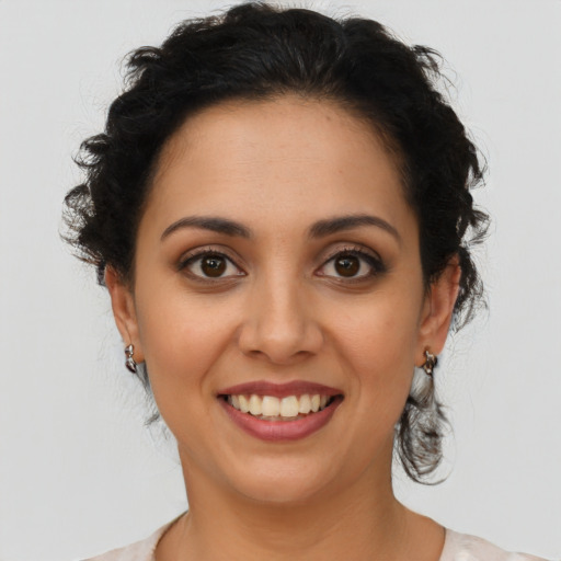 Joyful latino young-adult female with medium  brown hair and brown eyes