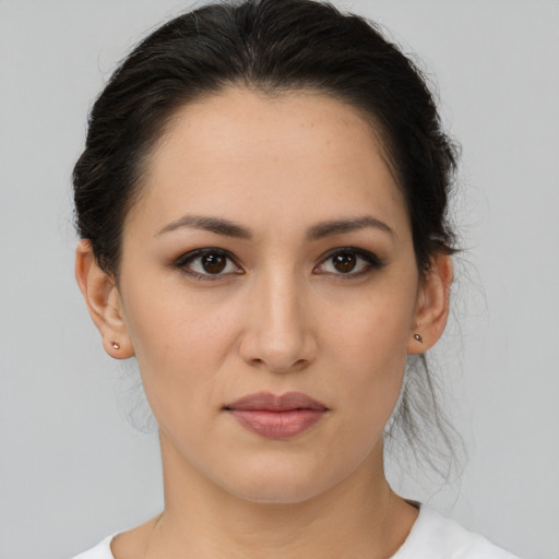 Joyful latino young-adult female with medium  brown hair and brown eyes