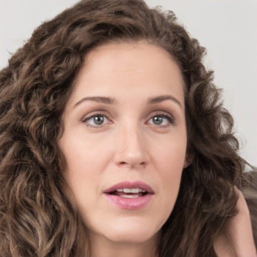 Joyful white young-adult female with long  brown hair and green eyes