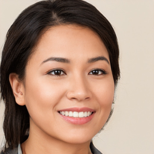 Joyful white young-adult female with medium  brown hair and brown eyes