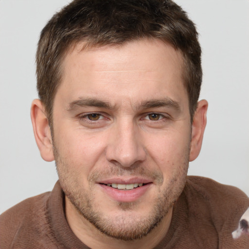 Joyful white young-adult male with short  brown hair and grey eyes