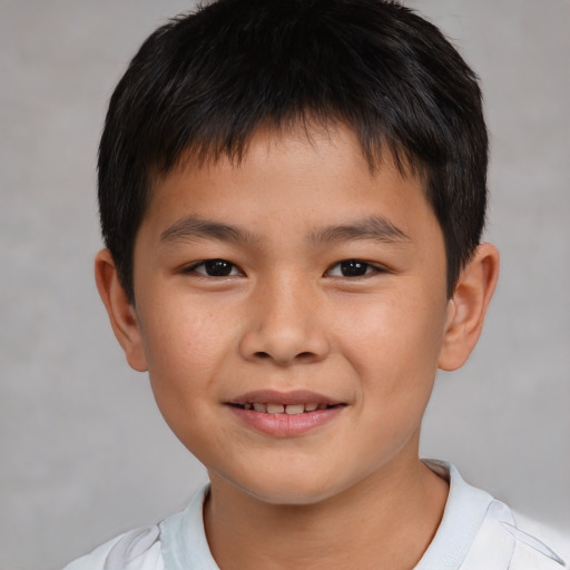 Joyful asian child male with short  brown hair and brown eyes