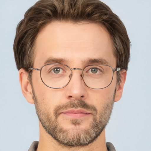 Joyful white adult male with short  brown hair and green eyes